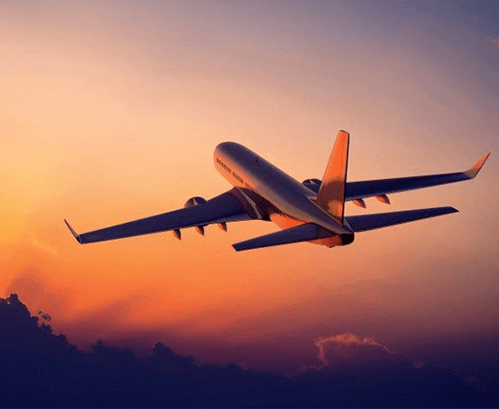 Plane flying in a sunset sky